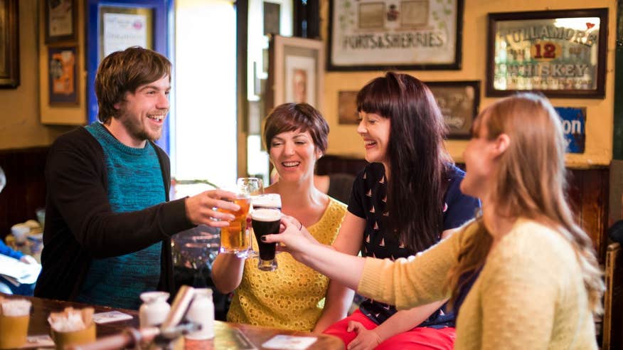 Friends enjoying a drink in a pub in Kenmare, Kerry.