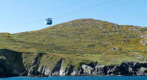 Cable car with land in the background and sea underneath