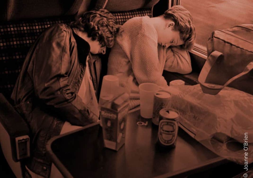 two women sleeping on train ride