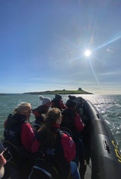 Passengers on a RIB tour with a small island in the distance