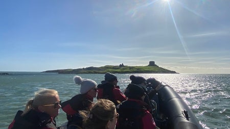 Passengers on a RIB tour with a small island in the distance