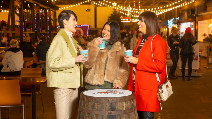 People having a drink in the Marina Market in Cork city at Christmas time