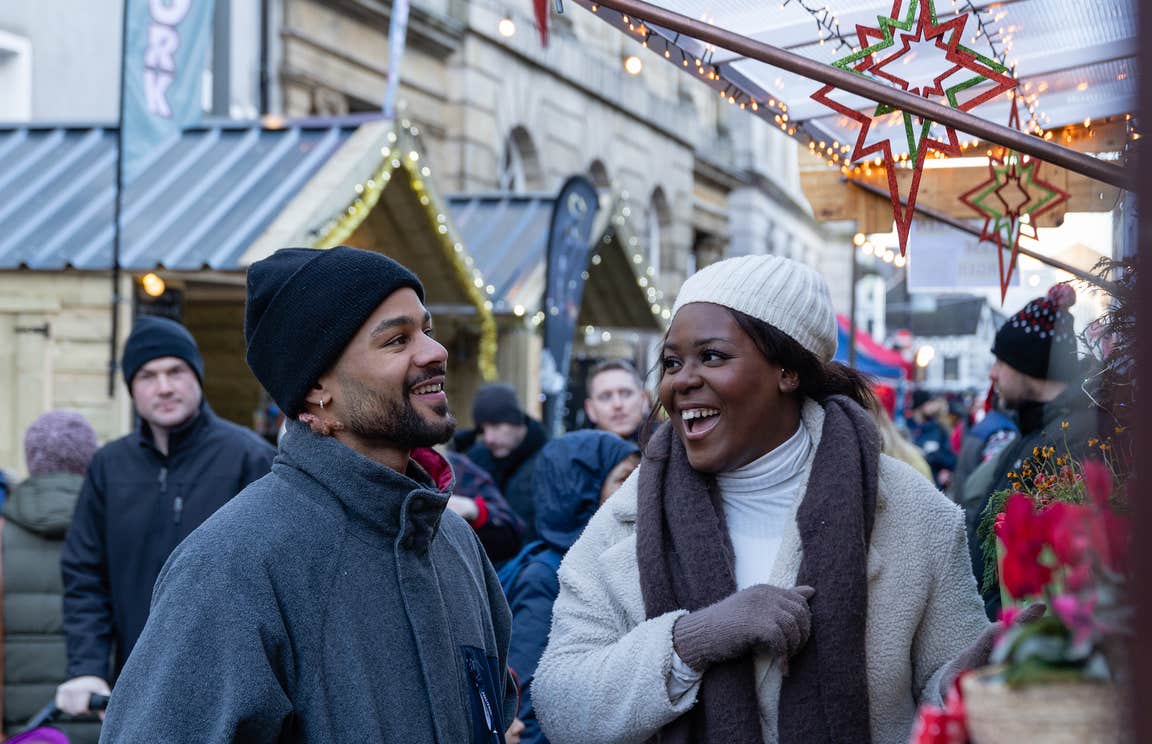 Couple laughing outside a chalet at Winterval.
