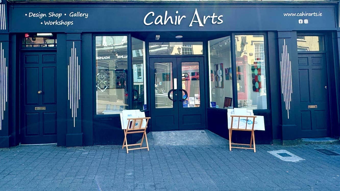 Art gallery exterior with small easels on display at the door