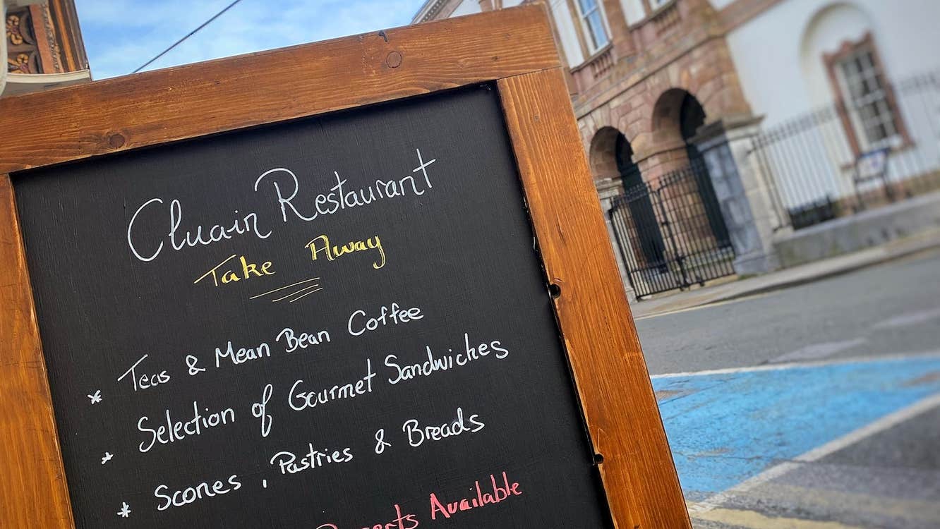 Cluain Restaurant take away menu displayed on a board outside the restaurant