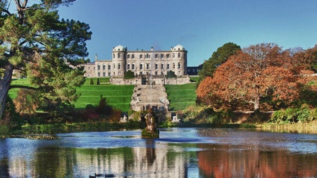 Historic mansion on a hill with a pond