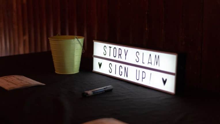 A rectangular light box with slim black writing on white background.