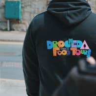 A person with their back to the camera wearing a hoodie with a Drogheda Food Tours logo