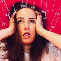 A woman looking upwards in despair with her hands either side of her head.