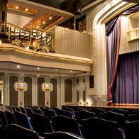 The stage and curtain of the set theatre from downstairs audience perspective and from the side