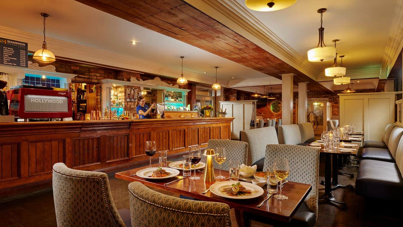 A dining area in a bar with prepared tables ready for diners