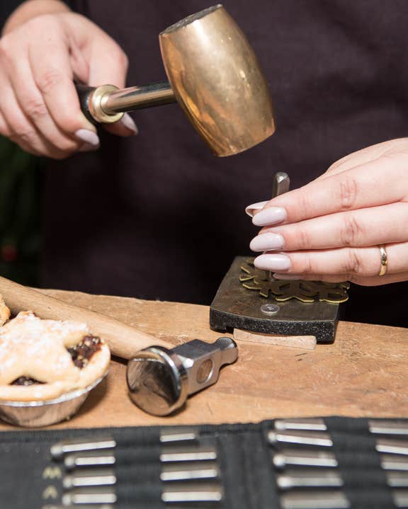 A person crafting a Christmas decoration in Silverworks in Dublin city