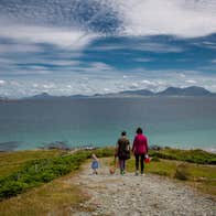Family on a path to the sea with dramatic sky