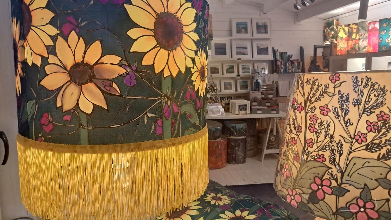A selection of crafts with floral themes on display in a studio
