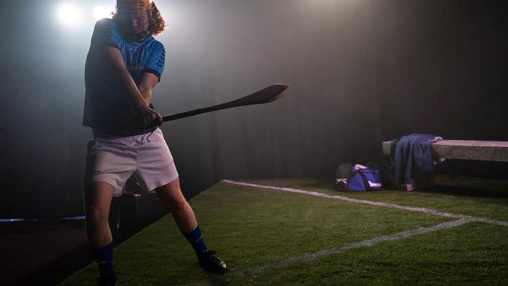 Dimly lit view of hurler on a pitch
