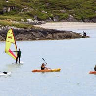 Three kayakers and 1 windsurfer in Derrynane