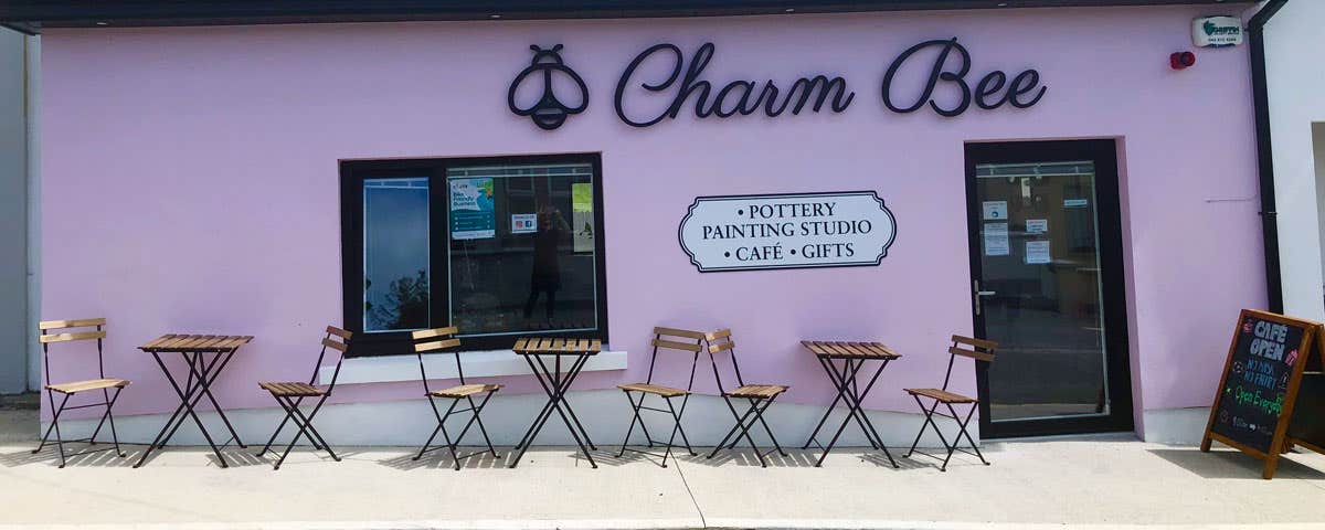 Exterior view of Charm Bee with café table and chairs outside