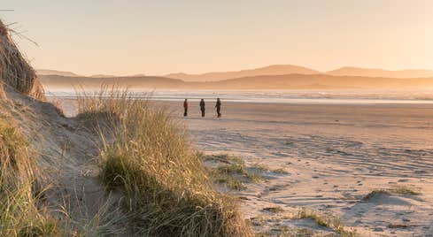 Sunset views and people walking at the beach in Co. Donegal