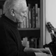 Side view of man playing a piano keyboard