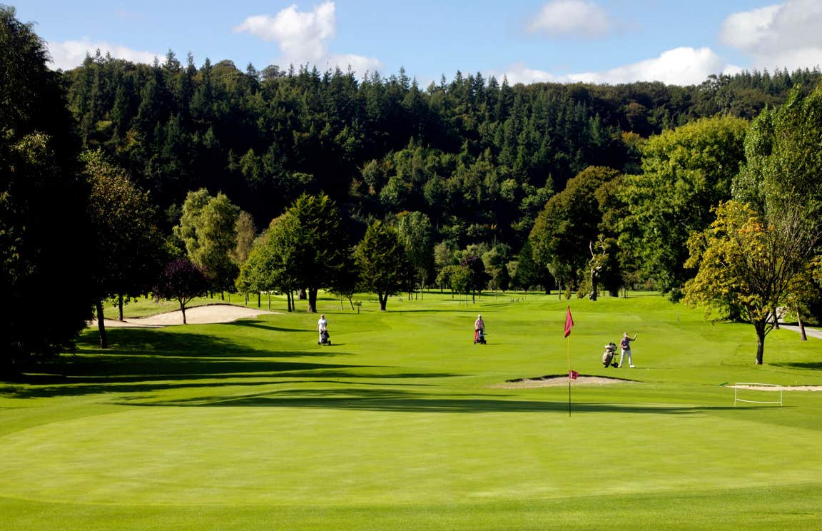 People playing golf on a sunny day at Woodenbridge Golf Course, Wicklow