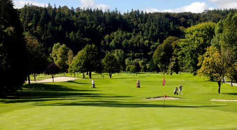 People playing golf on a sunny day at Woodenbridge Golf Course, Wicklow