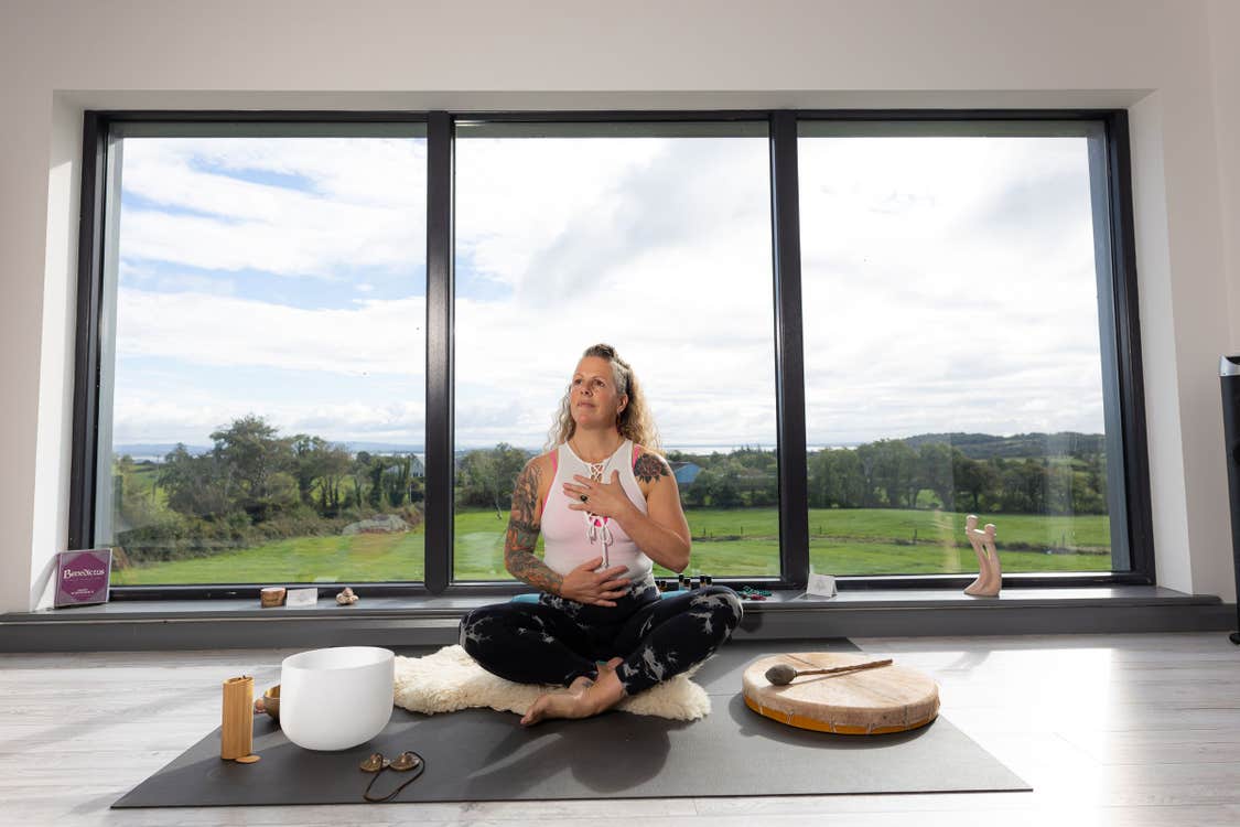 Woman sitting in yoga pose in a yoga studio