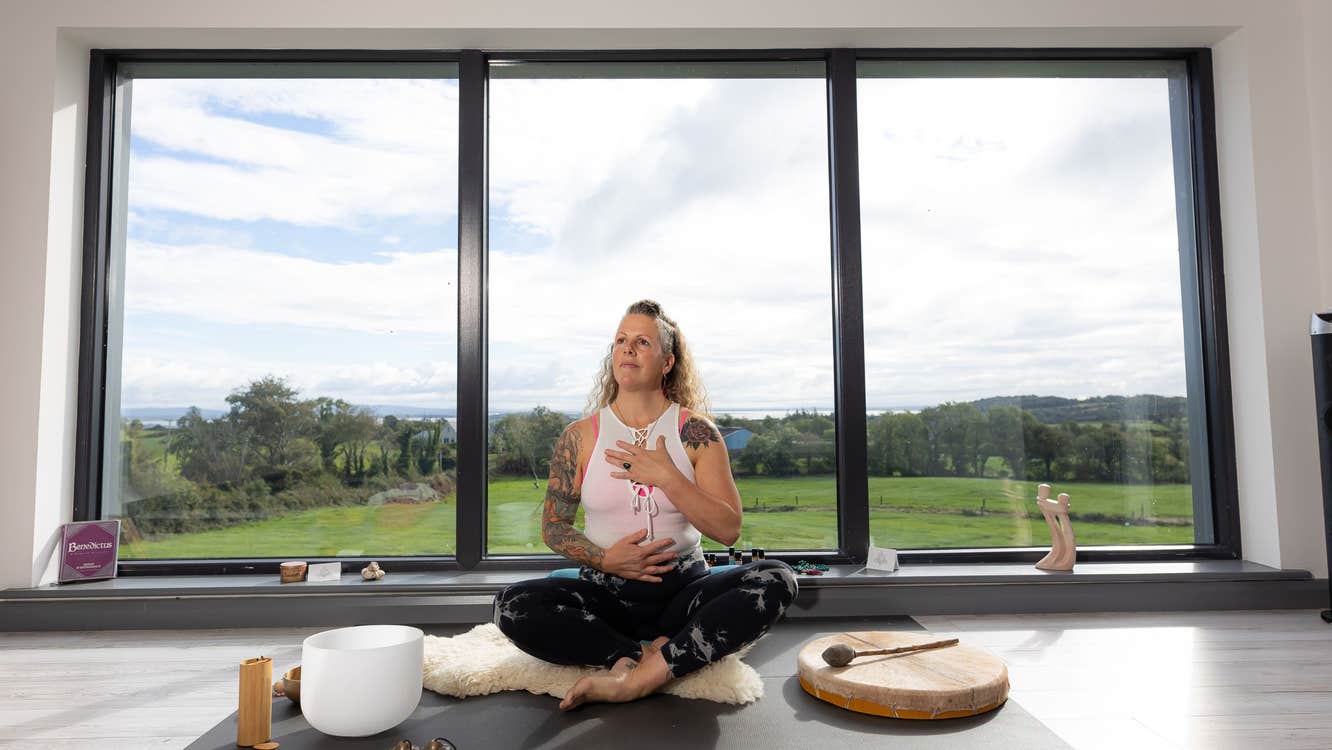 Woman sitting in yoga pose in a yoga studio