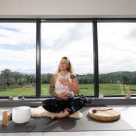 Woman sitting in yoga pose in a yoga studio