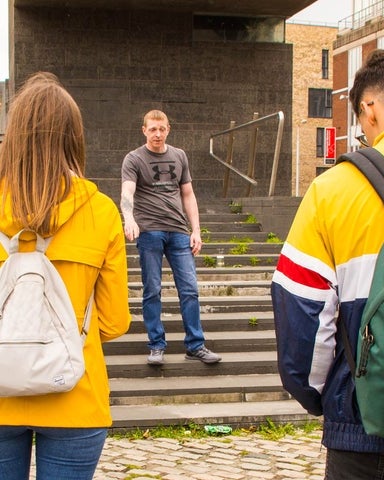 A guide speaking with a tour group in Smithfield Square