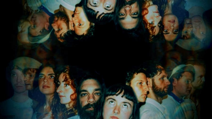 A line of headshots of people reflected above them upside down.