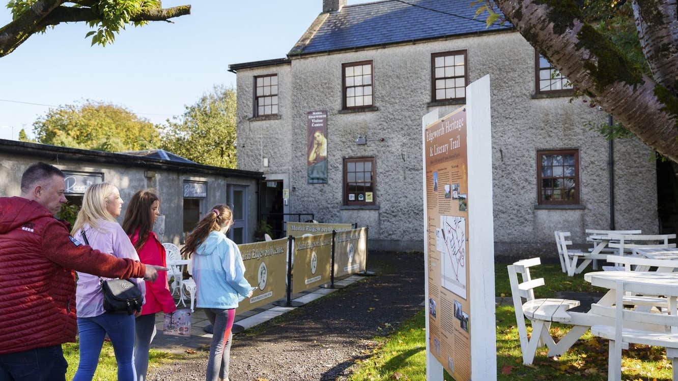 A family walking down the laneway to enter The Maria Edgeworth Visitor Centre