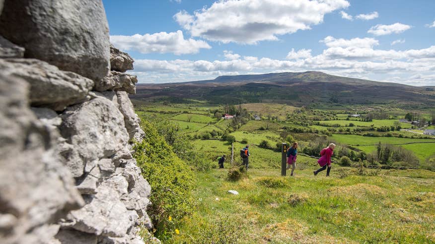 Four people walking on the Cavan Way trail in County Cavan.