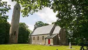 Timahoe Round Tower with Heritage Centre next door