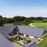 An aerial view of a golf club house and the course