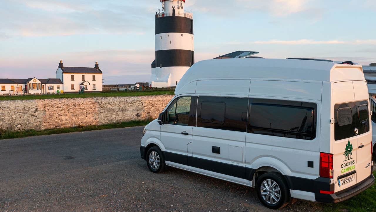 Cookies Camper parked by a lighthouse