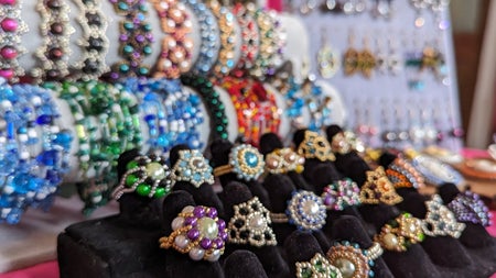 A selection of colourful jewellery for sale in a market stall