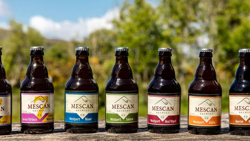 Selection of different types of Mescan bottled beer displyed on a table