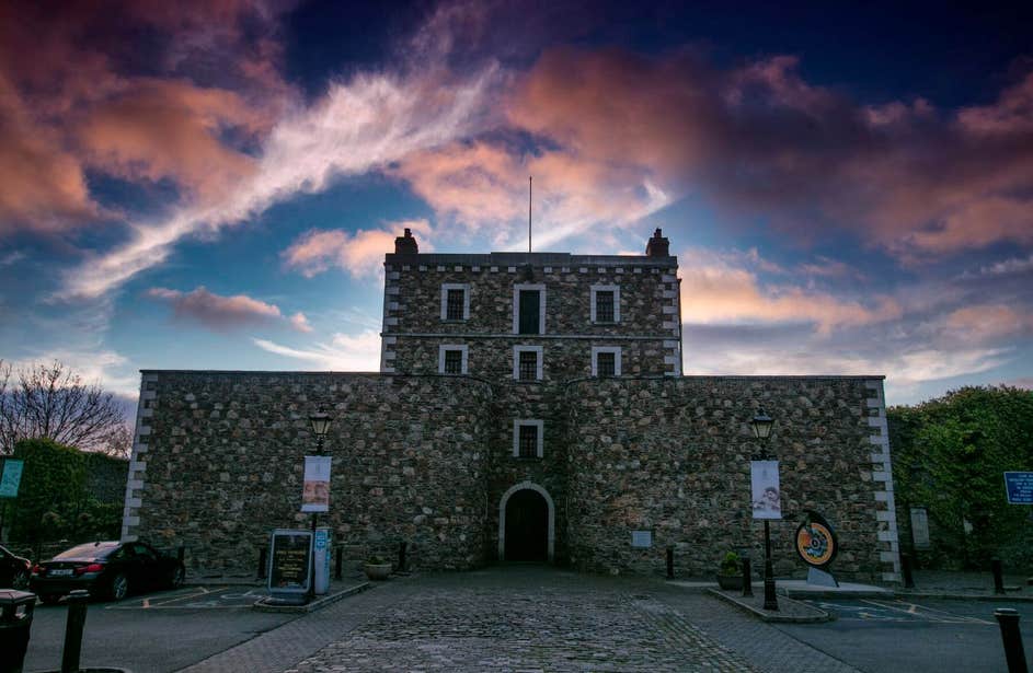 Exterior facade of Wicklow Gaol with the sky edited to be pink and purple to give off a creepy vibe.