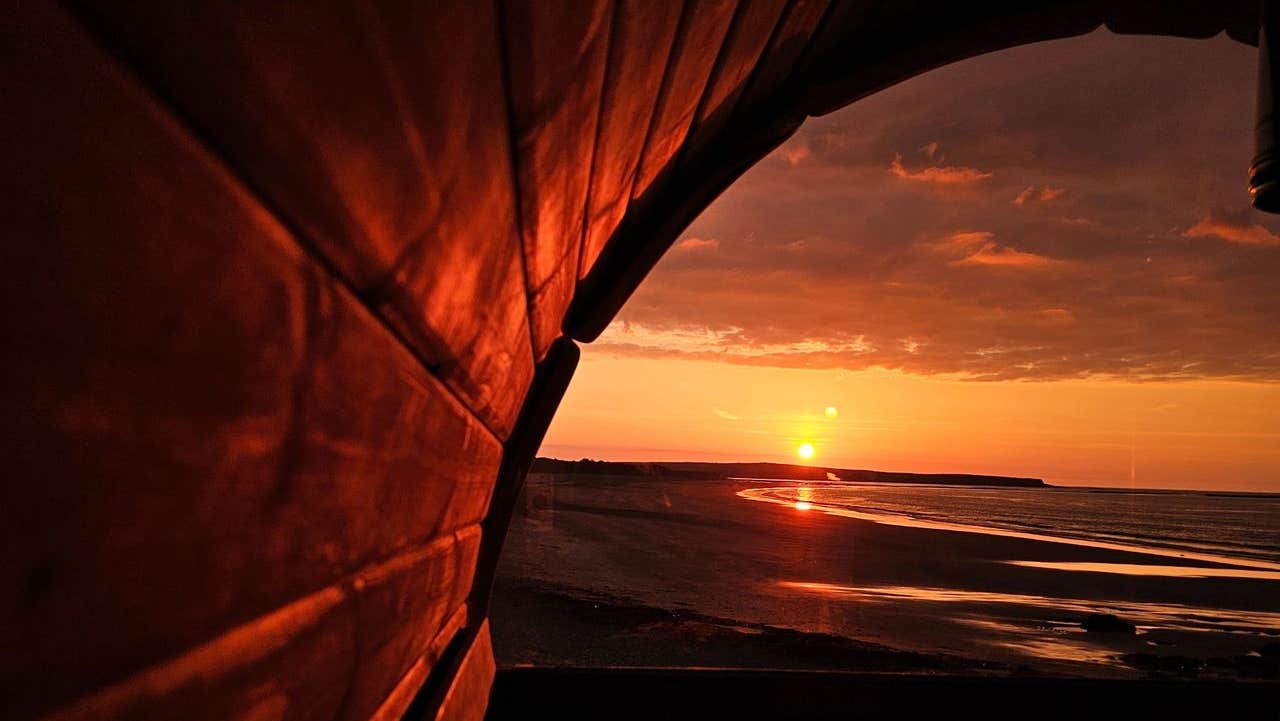 View of the beach from a sauna at sunset