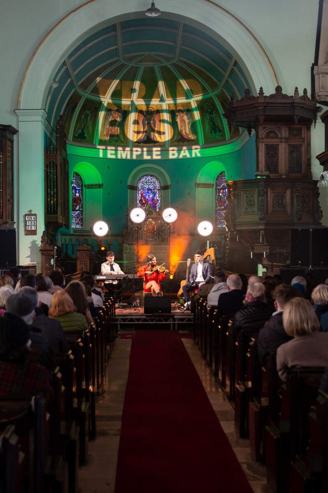 Rows of people watching musicians at TradFest.