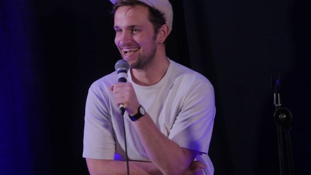 A comedian with a microphone in his hand