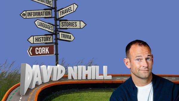David Nihill: Taking Tangents. A man with rye smile next to a sign post with many signs pointing in various directions.