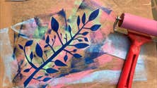 Monoprinting with Susan Leen - Looking down at a printed, layered image of a branch with different colours and a small roller.
