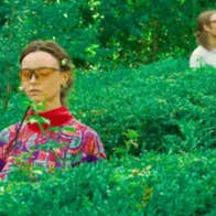 A photo of Sei Green standing in middle of hedges