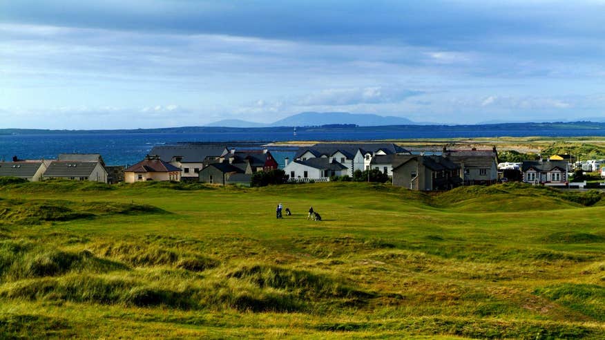 People playing a round of golf by the sea at Strandhill Golf Club, Sligo