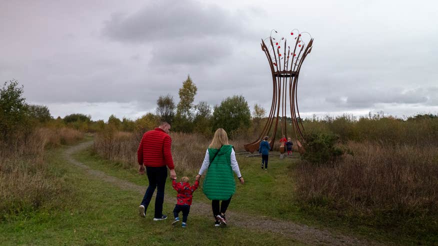 A family looking at the outdoor sculptures at Lough Boora Discovery Park in County Offaly.