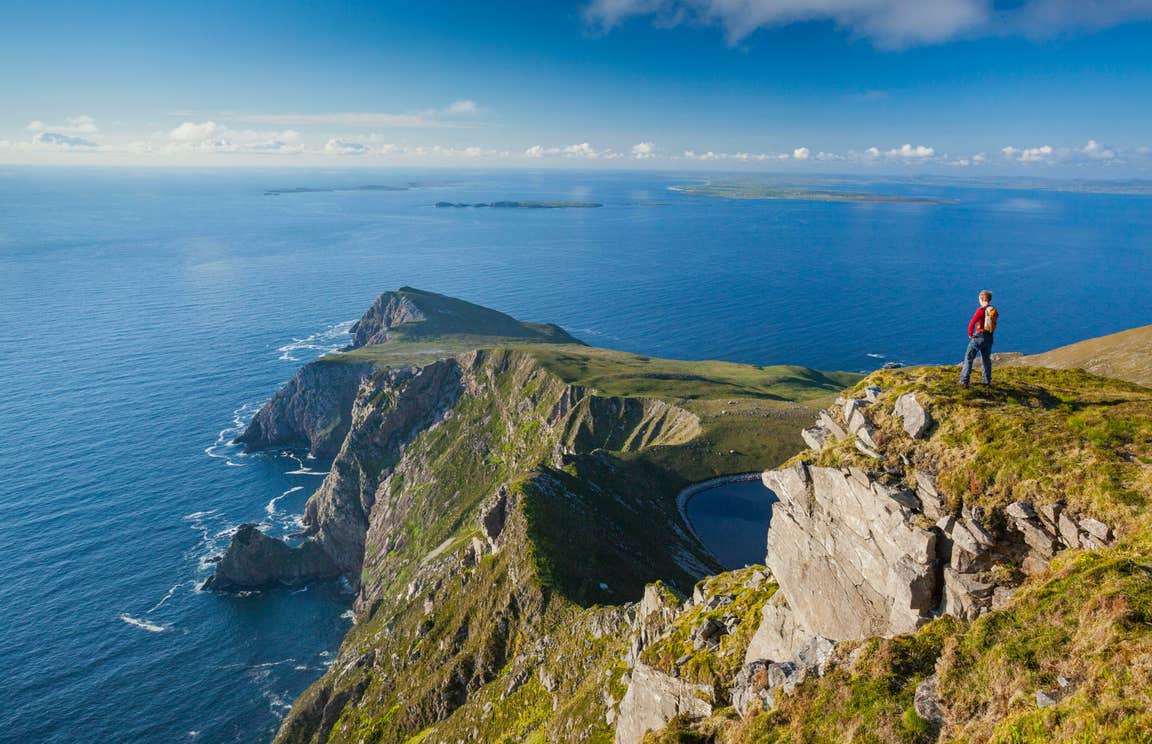 Person standing on a clifftop looking at Croaghaun, Achill Island, Co Mayo