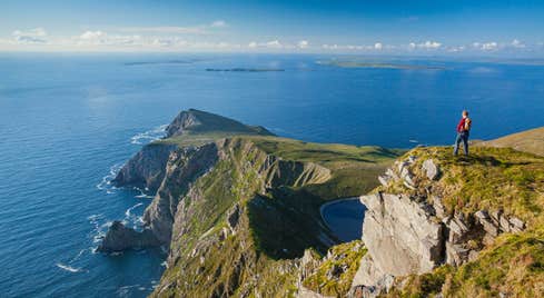 Person standing on a clifftop looking at Croaghaun, Achill Island, Co Mayo