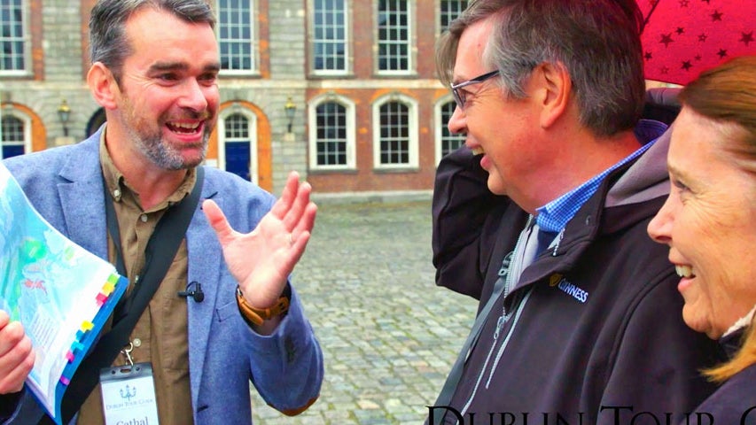 One of the guides with name badge Cathal Sheehan talking to a couple on the tour with a map visible in his hand