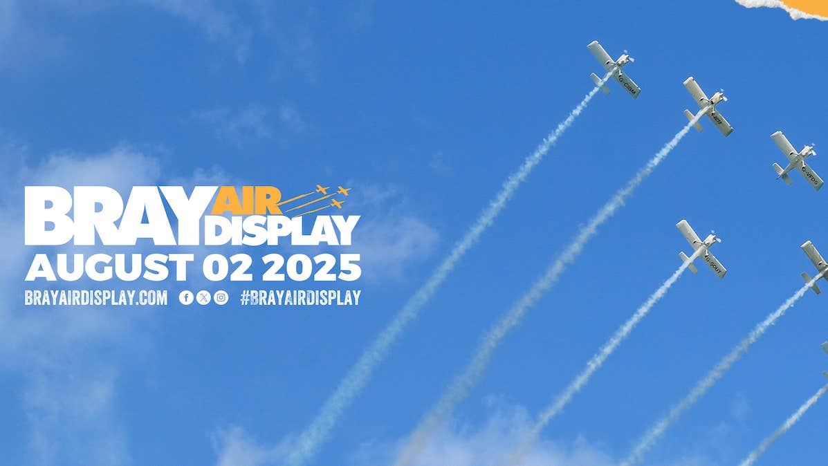 A bright blue sky with a group of 6 aircraft flying in a line, seen from below
